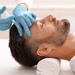 Middle-aged man having hair treatment